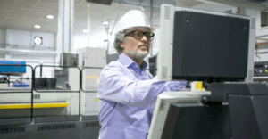 man looking at machinery